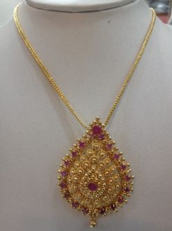 25. Beautiful locket with art ruby stones around